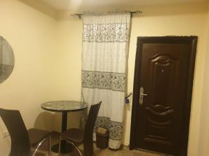 a room with a door and a table and chair at Joefad Home Stay - Wuse Zone 5 in Abuja