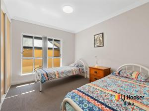 a bedroom with two beds and a window at Riverview Apartments 1 3 Building 1 Unit 3 in Iluka