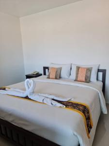 two beds sitting next to each other in a bedroom at Chom By The Sea in Ao Nam Mao