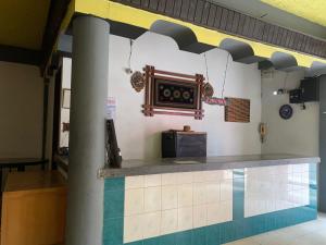 a restaurant with a counter with a dj equipment on the wall at OYO 93237 Hotel Triarga in Takengon