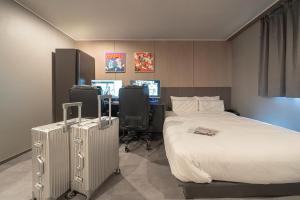 Ένα ή περισσότερα κρεβάτια σε δωμάτιο στο Workers Hotel Ansan by Aank
