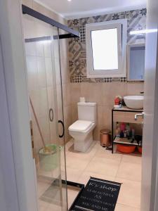 a bathroom with a toilet and a sink at Faliro Athens fully equipped sea view apartment 200m to beach in Athens