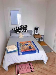 a bedroom with a bed with a teddy bear on it at Faliro Athens fully equipped sea view apartment 200m to beach in Athens