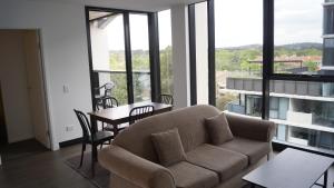 a living room with a couch and a table at Smart apartment right in Canberra CBD in Canberra
