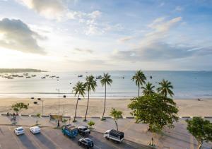a parking lot next to a beach with palm trees at Sontra Sea Hotel in Danang