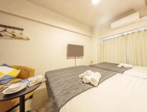 Postel nebo postele na pokoji v ubytování Apartment Hotel 11 Shinsaibashi 2 + 34 fotografií