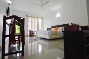 a living room with a bed and a couch at Siyanco Holiday Resort in Polonnaruwa
