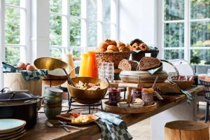 a table with bread and other food on it at Kasteel Kerckebosch in Zeist