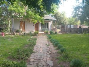 a house with a stone path in front of a yard at Royal Karoo Cottage in Beaufort West