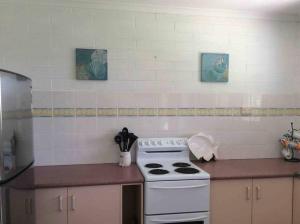 a kitchen with a stove and a counter top at Totally Beachin! - walking distance to the beach in Eden
