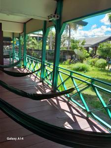 a hammock on the porch of a house at Tavan Seng 3 in Don Det