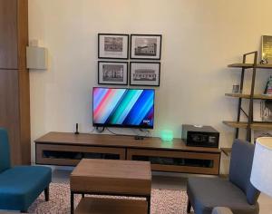a living room with a television on a table at IPOH 8Perkins Canning Garden 7-8pax Elegant Homestay with 4Bedrooms, 3Bathroom, 1Living, 1Dining, 1Kitchen-Bar with 3Parkings in Ipoh
