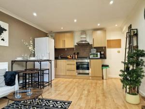 a kitchen and living room with a couch and a table at Paddington in London