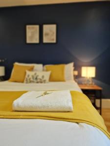 a bedroom with two beds with yellow and blue walls at Paddington in London
