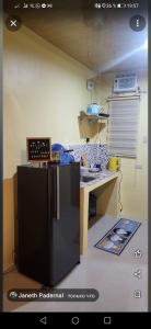 a kitchen with a desk and a counter in a room at Bluewaves Apartment in Dauis