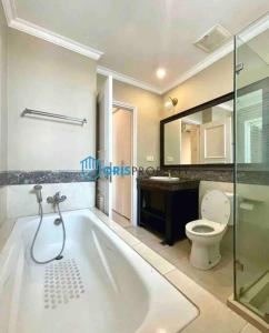 a bathroom with a bath tub and a toilet at Lovely 3-Bedroom rental unit in Jakarta