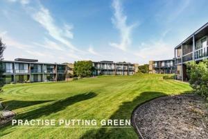 an image of a green yard in front of apartment buildings at Scenic Golf & Spring 1BR Getaway in Fingal