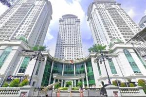 a large building with tall buildings in the background at Lovely 3-Bedroom rental unit in Jakarta