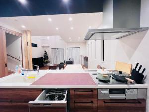 a kitchen with a counter top with a stove top at Zaki-House in Tokyo