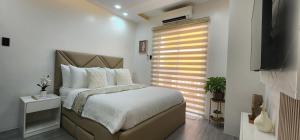 una camera con un grande letto e una finestra di CozyNest - Modern 1 Bedroom Gem Luxury Smart Unit a Angeles