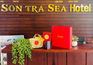 a table with a red book and other items on it at Sontra Sea Hotel in Danang