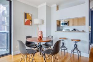 a dining room with a table and chairs at Midtown 1BR w Water views Indoor pool NYC-36 in New York
