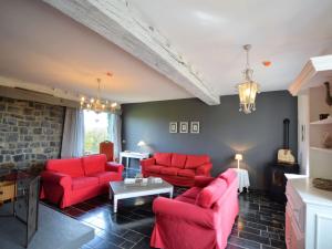 a living room with red furniture and a brick wall at Attractive Holiday Home in Gerin near centre in Gerin