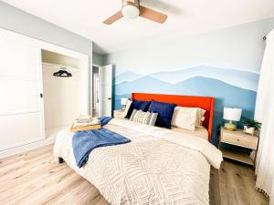 a bedroom with a large bed with an orange headboard at Retreat Minutes To LAX, Manhattan/ Redondo Beach in Torrance