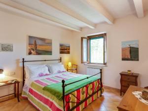 a bedroom with a bed and a table and a window at Farmhouse in Ville di corsano siena at the centre in Corsano