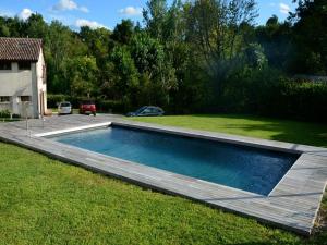 a swimming pool in the yard of a house at Modern Farmhouse in Pagnano Italy near Forest in Asolo