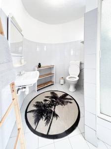 a bathroom with a palm tree on the floor at Tamarin River Villa in Tamarin