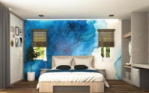 a bedroom with a bed and a blue wall at Ko Lanta Amantra Lake View Resort in Ko Lanta