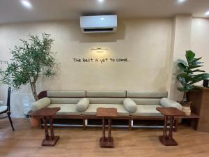 a couch in a room with a sign on the wall at Hanoi Street Hotel in Hanoi