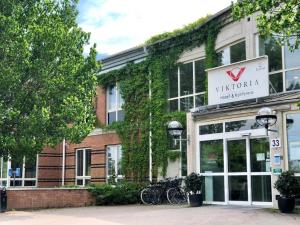 a building with a sign that reads nederlandaza at Viktoria Hotell & Konferens in Uppsala