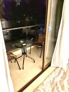 a small table and chairs on a balcony at night at The Address 2 in Nairobi