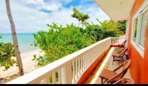 a balcony with chairs and a view of the beach at Malapascua Beach and Dive Resort in Logon