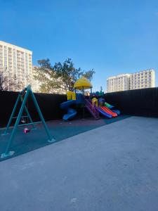 a playground with a play set and a slide at Atlantis in Bishkek