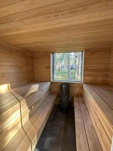 a large wooden room with a window in a sauna at The Lighthouse in Pāvilosta