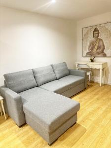a living room with a couch and a table at Twickenham studio private apartment in Twickenham