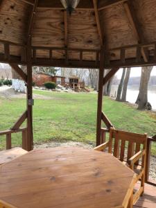 a wooden gazebo with a wooden table and chairs at Morels on the Wabash in Logansport