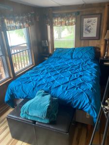 a bed in a room with a blue comforter at Morels on the Wabash in Logansport