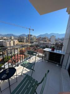 a balcony with chairs and tables and a view of a city at Mozart House - Spacious Luxury Apartment - Heart of the City in Tirana +59 photos