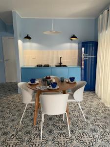a kitchen with a table and chairs in a room at Case Borgo Vacanze in Letojanni