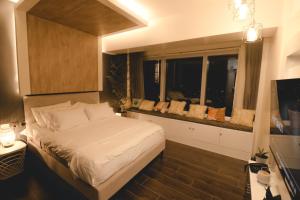 a small bedroom with a bed and a window at Davao Rental - AEON Towers Condo 1BR Suite 1Bathroom with Bathtub, Kitchen, Living Room in Davao City