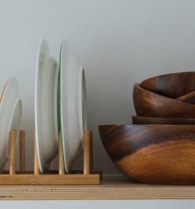 a shelf with several wooden bowls on it at Near Gangneung Station House in Gangneung