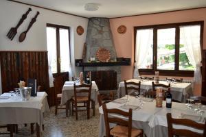 a restaurant with tables and chairs with white tablecloths at Albergo Diana in Tronzano Lago Maggiore