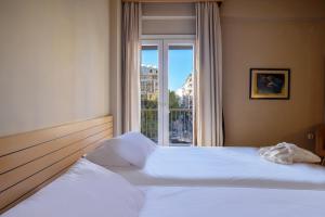 a bedroom with a large bed with a window at Astoria in Thessaloniki