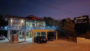 a building with a car parked in front of it at Ban Suweena in Uthai Thani
