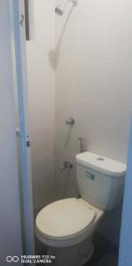 a bathroom with a white toilet and a shower at Diaz Residence in Silang