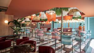 a rendering of a restaurant with colorful stools at tent Mojito Suites in Magaluf